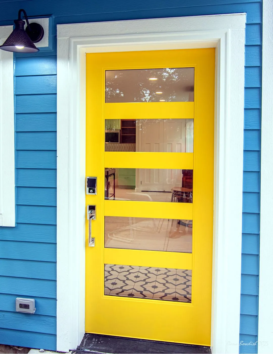 Bright yellow exterior door detail at the View Ridge DADU