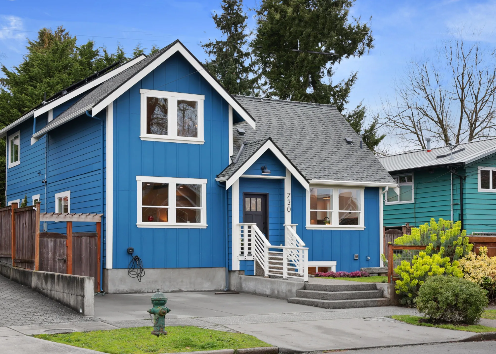Completed whole house remodel with blue exterior siding, white trim, and improved living space