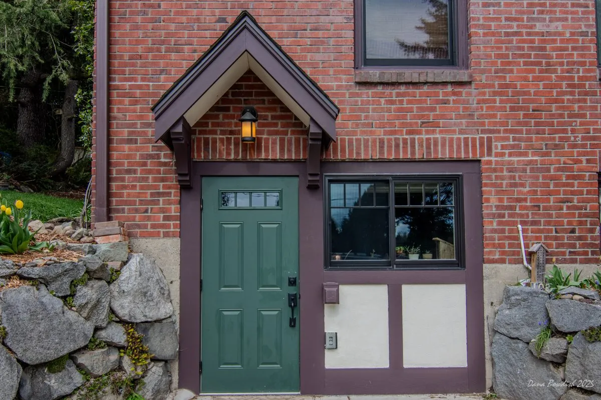 Covered entry with a rebuilt door at a Silver Peak Tudor restoration