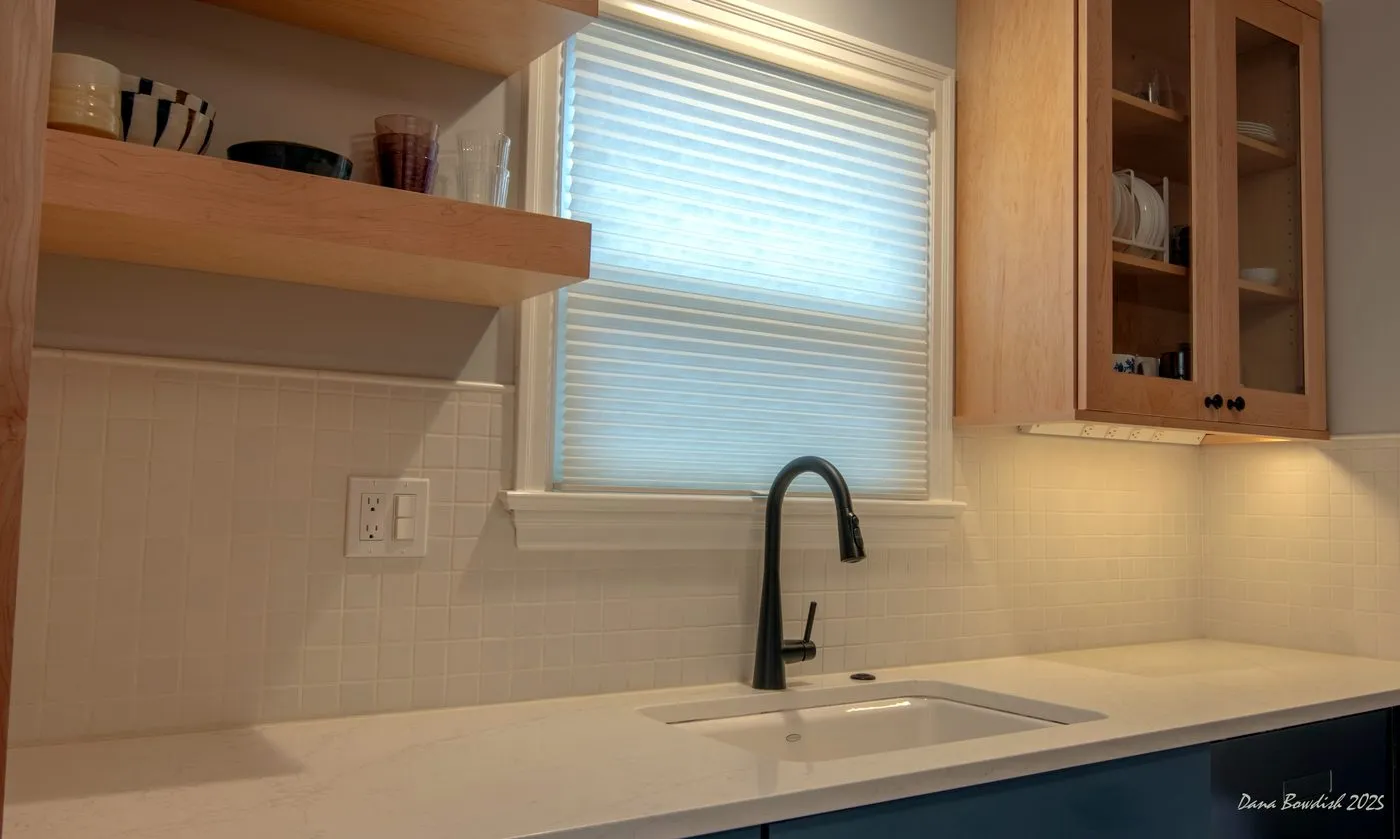 Open shelving, sink wall, and cabinetry in the Licton Springs kitchen remodel