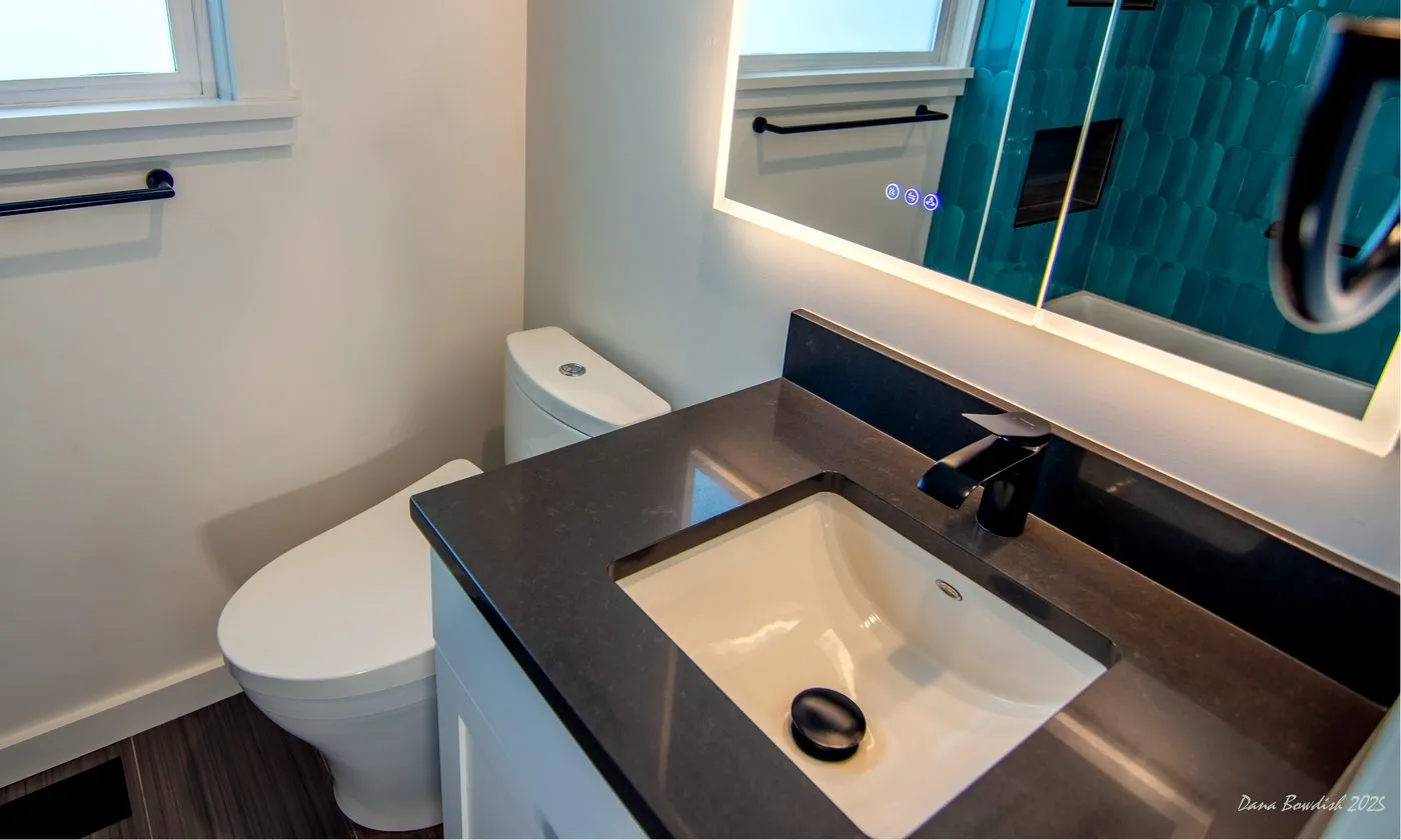 Vanity, sink, mirror, and toilet area in the Bitter Lake bathroom remodel