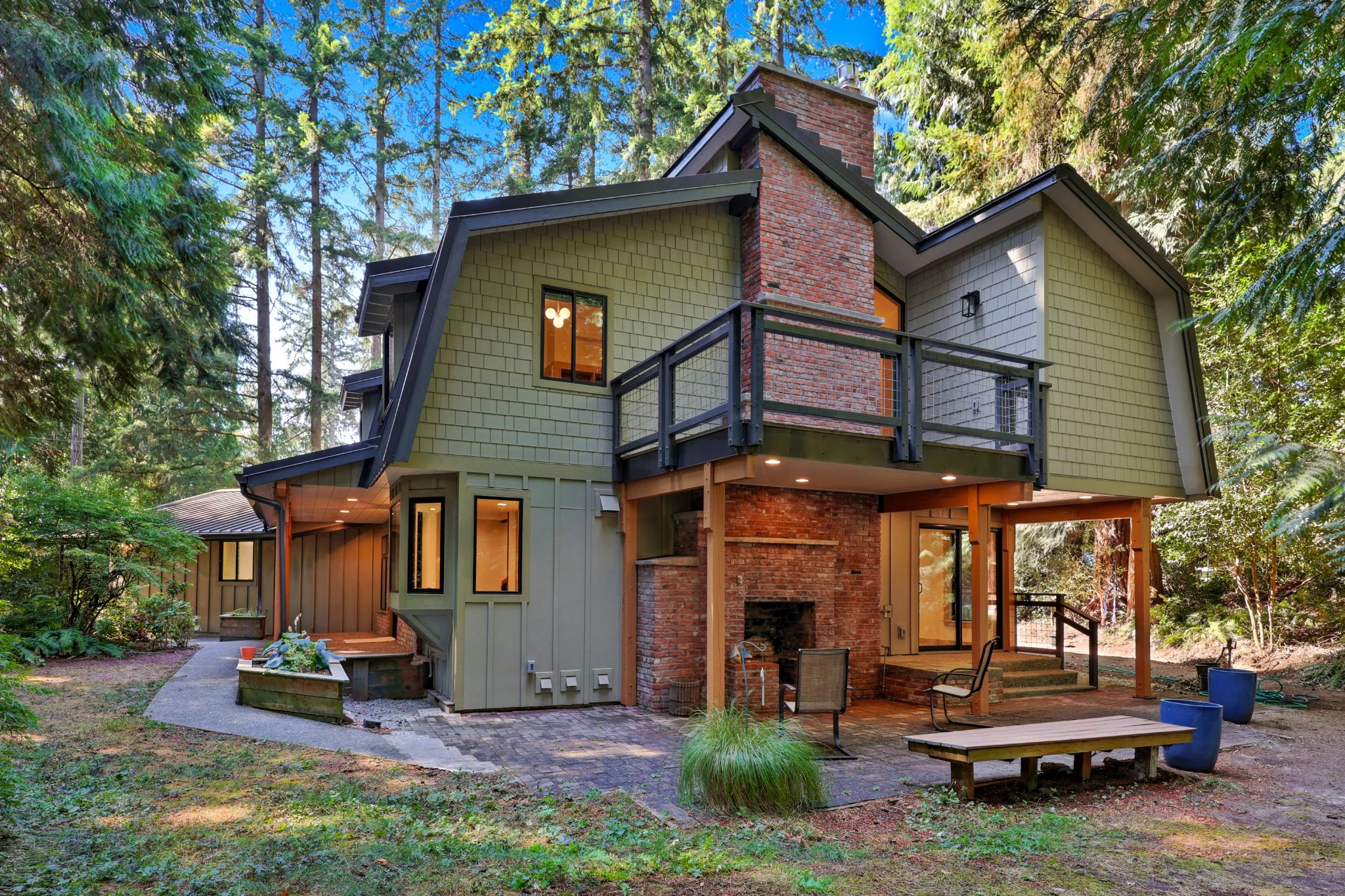 Renovated house exterior with covered patio and mature trees