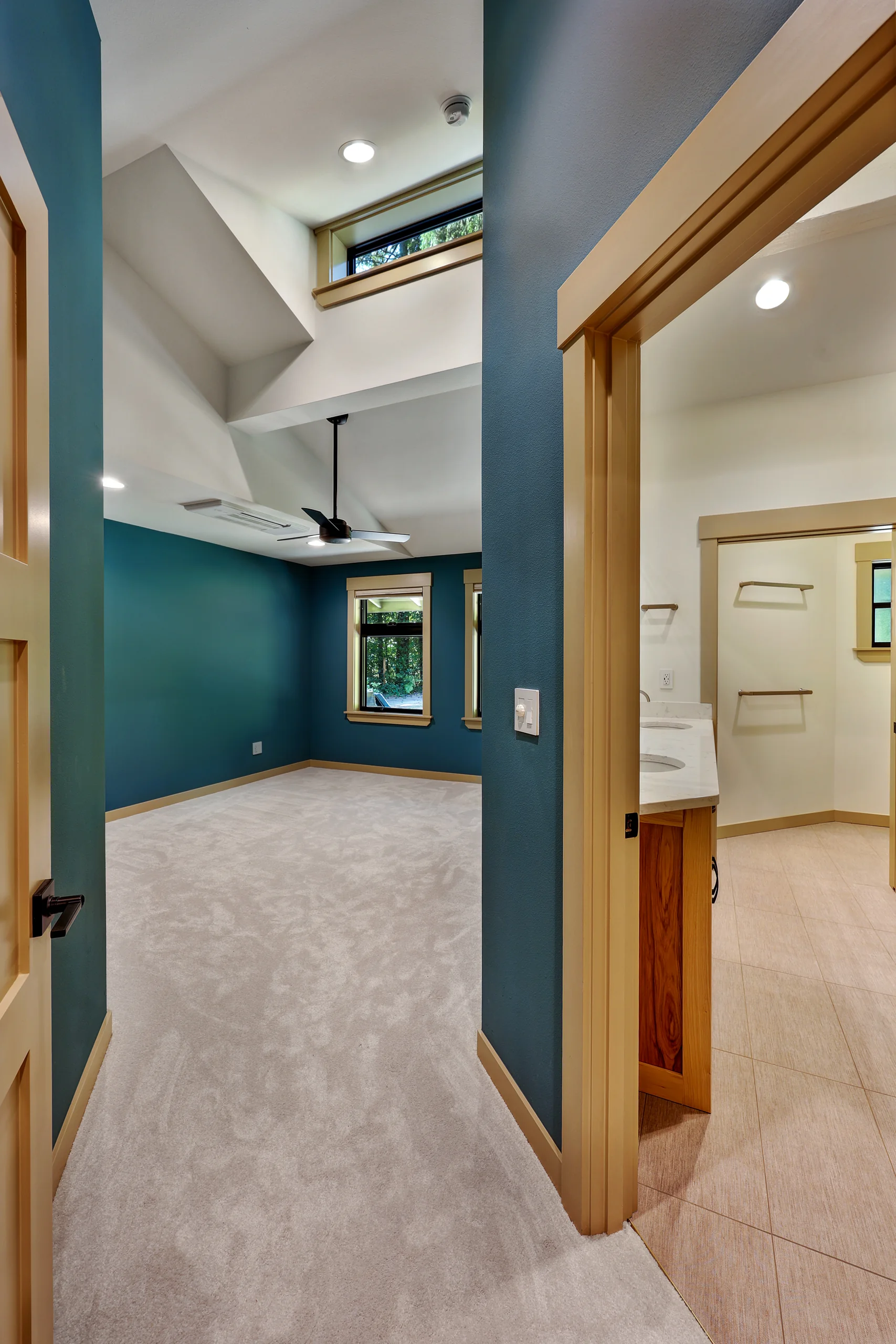 Hallway with painted doors and a view into adjoining rooms