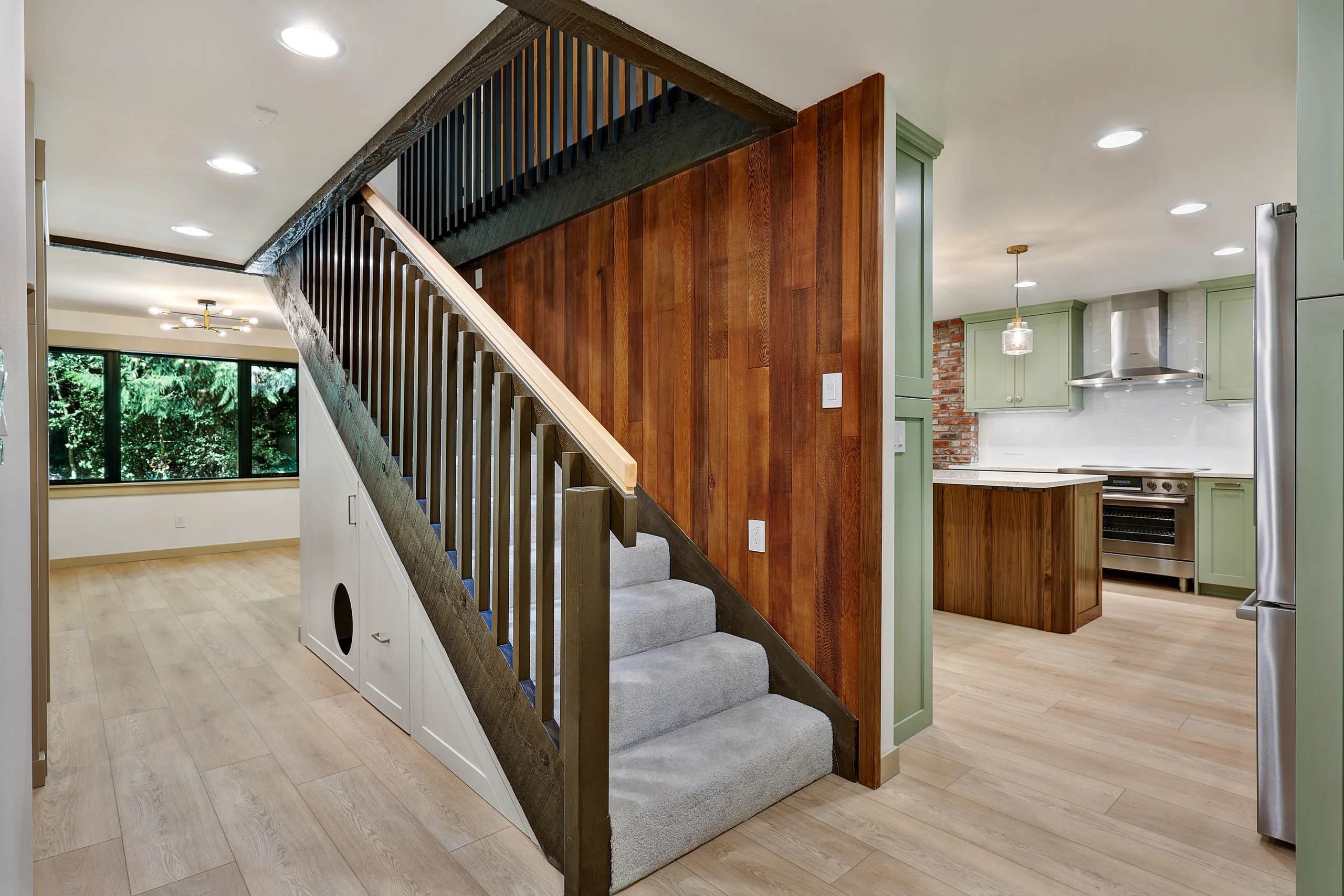 Wood stairway connecting the kitchen and living area